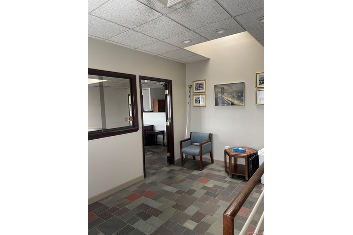 Living area featuring baseboards and a drop ceiling