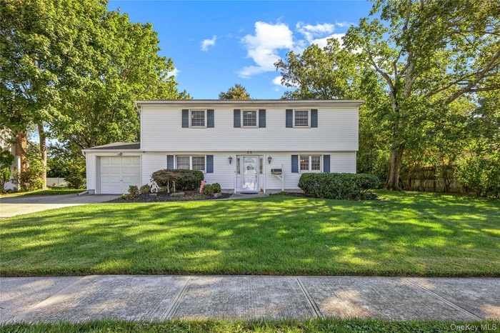 Colonial home with driveway and a garage