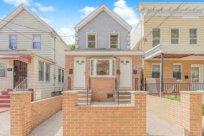 View of front of home with brick siding and stucco siding