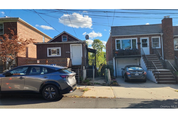 View of front of home featuring brick siding, concrete driveway, and a garage