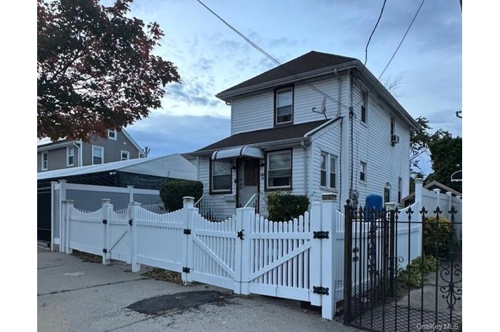 View of front of property with a gate and a fenced front yard