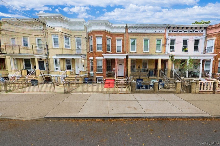 View of front facade with a fenced front yard and brick siding