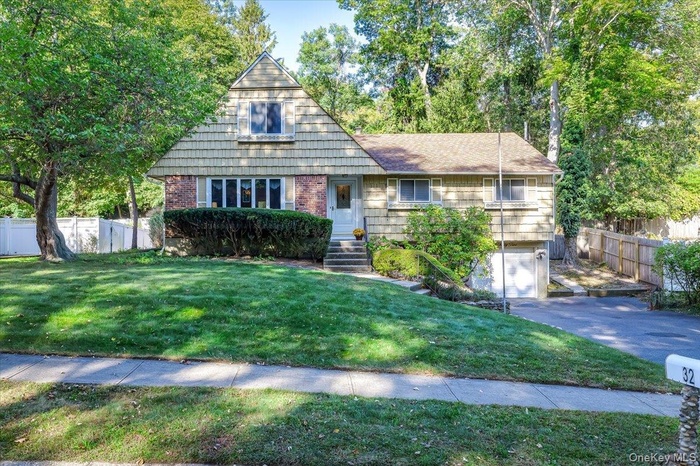 View of front of home featuring an attached garage, and driveway