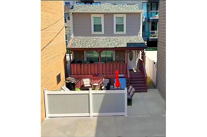 View of front facade featuring a shingled roof and a patio area....parking for 6 cars