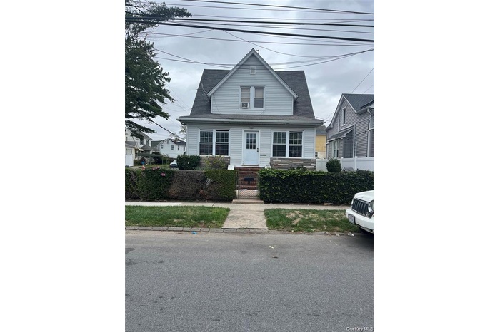 Bungalow with a gate and a fenced front yard