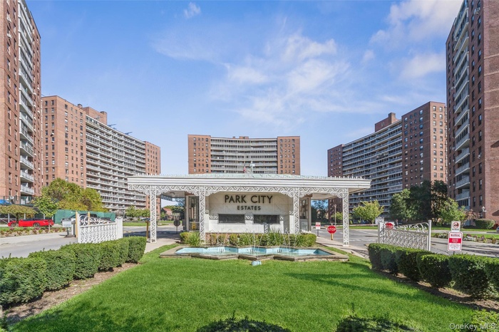 Surrounding community featuring a view of city and a lawn
