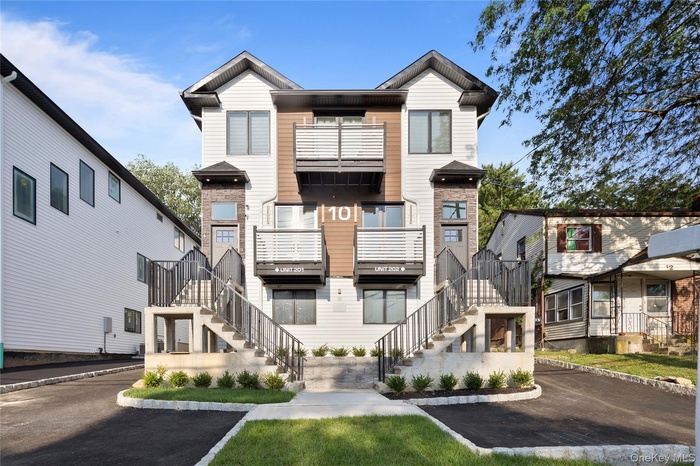 View of property featuring stairs