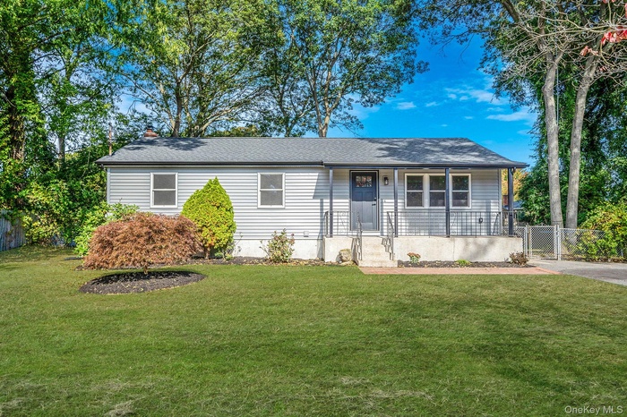 Single story home with covered porch, a gate, a chimney, and roof with shingles