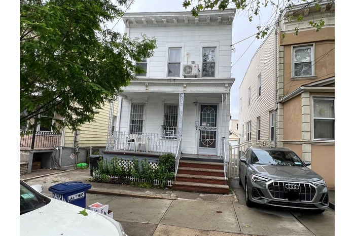 View of front of home with covered porch and a cooling unit