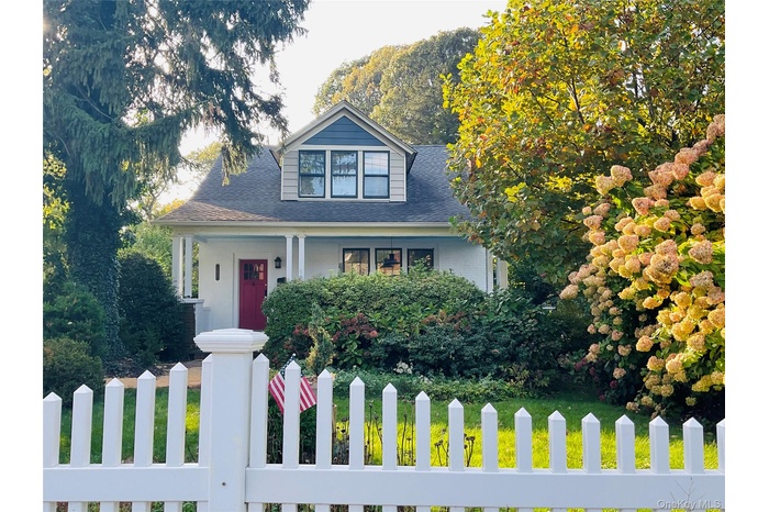 View of front of property featuring a fenced front yard, a granny porch, and newer roof.
