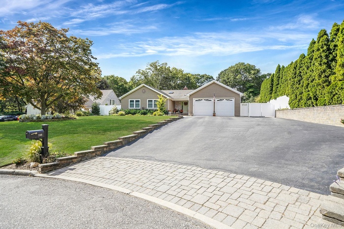 Ranch-style house with asphalt driveway and an attached garage