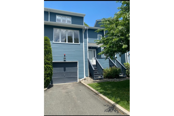 View of front of house with an attached garage and driveway