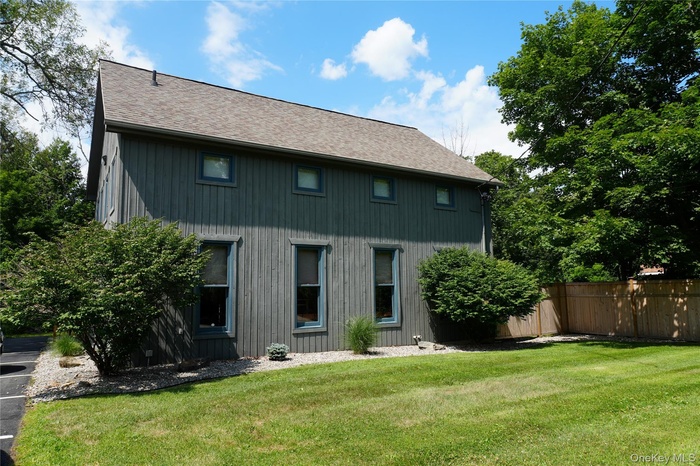 Back of property featuring roof with shingles