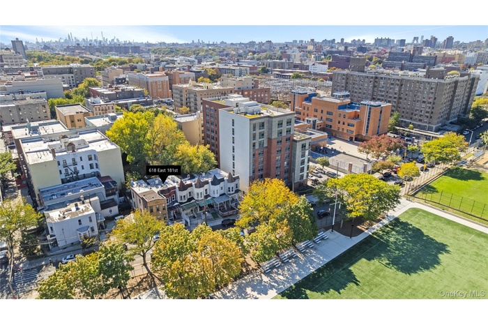 Stunning aerial view of your future home, perfectly situated with panoramic views of the city skyline and a beautiful park just across the street. Thi