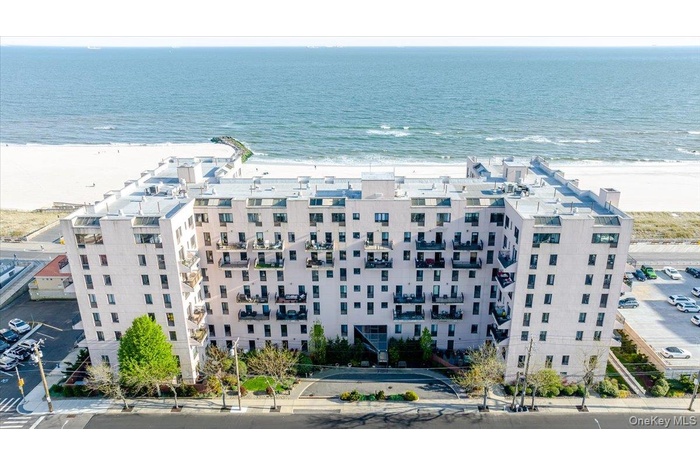 Drone / aerial view of apartment complex / building and unending shoreline