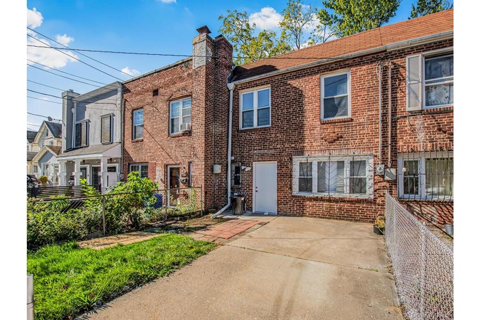 Traditional-style home with brick siding, a chimney, and a patio area