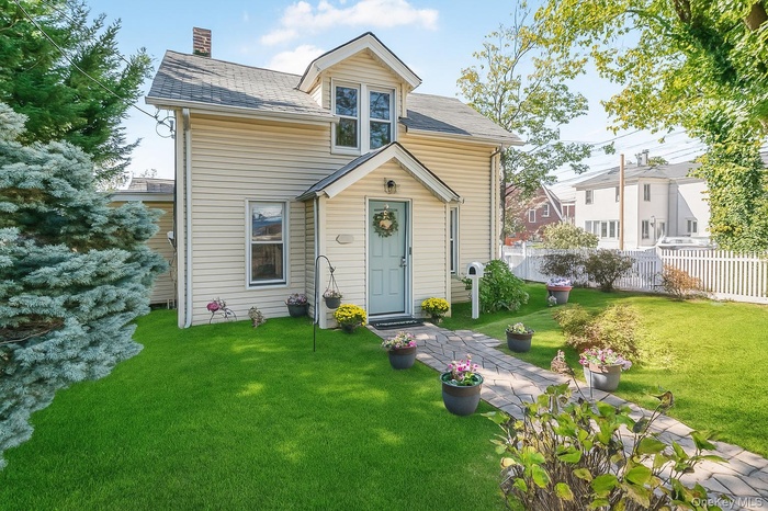 Bungalow-style house with a chimney and a shingled roof