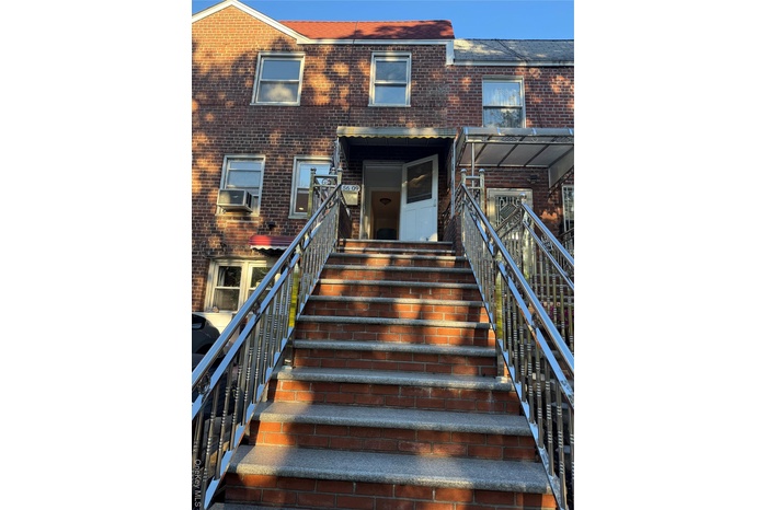 View of front of house with brick siding and stairway