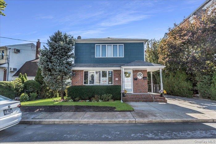 Traditional-style home with brick siding