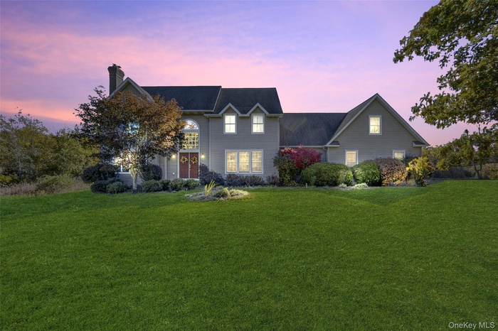 Traditional-style home with a front yard and a chimney