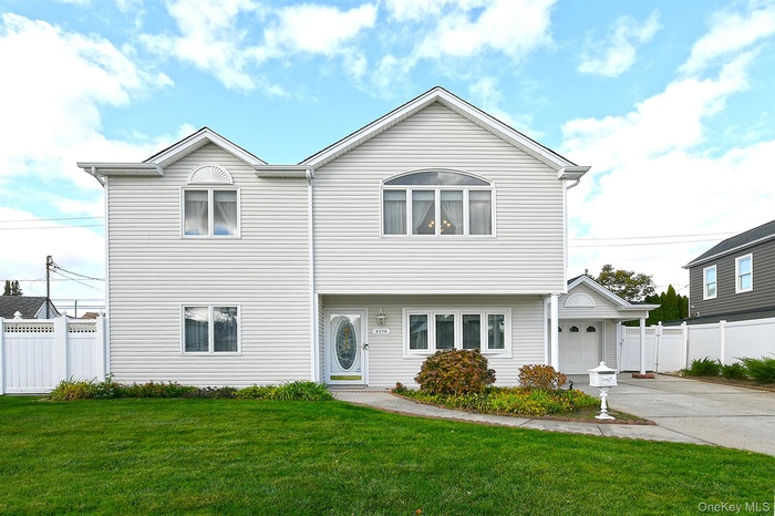 View of front of home with driveway and a garage