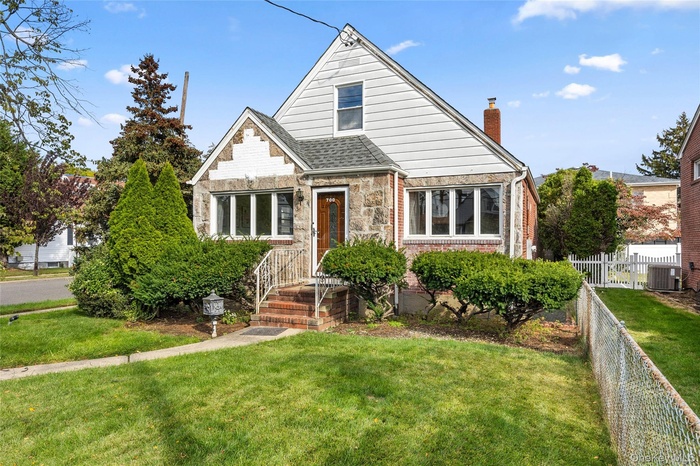 Bungalow with brick siding and a chimney