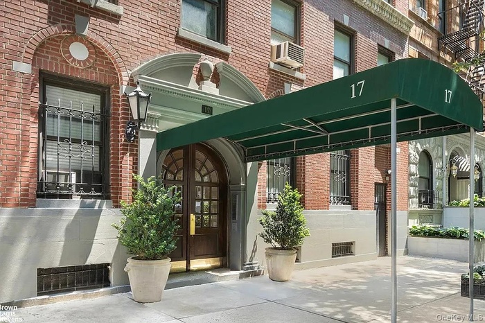 Property entrance featuring brick siding and french doors