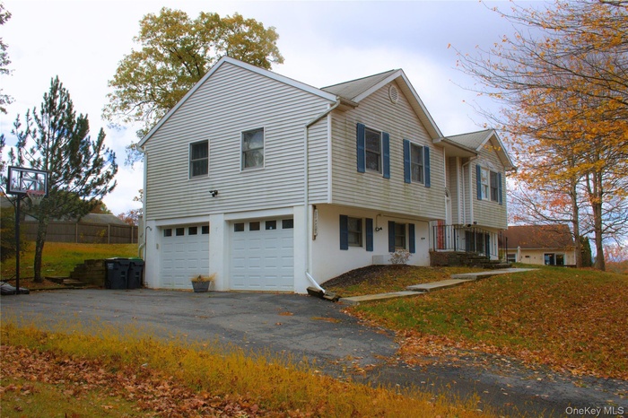 View of home's exterior with asphalt driveway and an attached garage