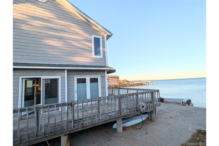 Back of house featuring a water view and a balcony
