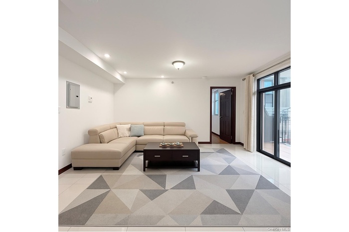 Living area with electric panel and recessed lighting