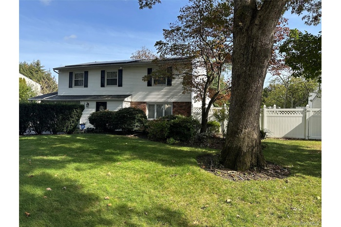 Traditional-style house with brick siding