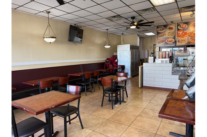 Dining space featuring a drop ceiling, tile patterned floors, visible vents, and ceiling fan