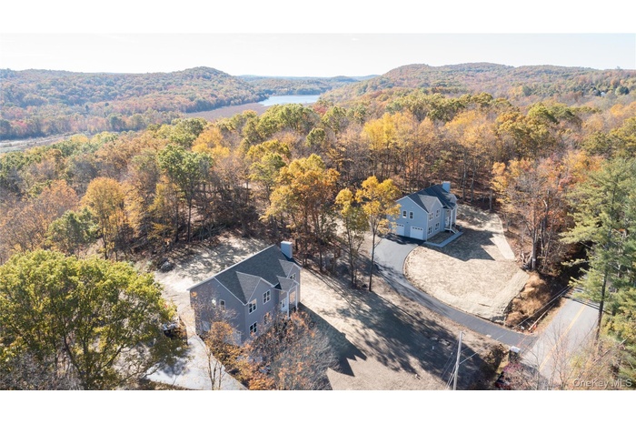View from above of property featuring a forest and a mountain backdrop