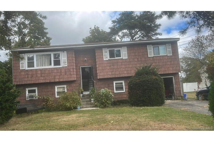 Split foyer home featuring a front lawn