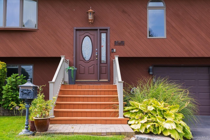 Doorway to property with a garage