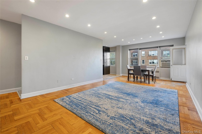 Dining area featuring recessed lighting, radiator, and cooling unit