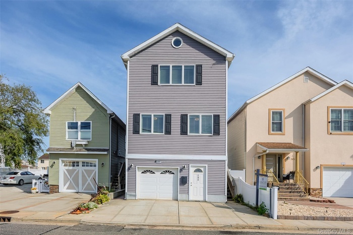 Traditional-style house featuring driveway and an attached garage