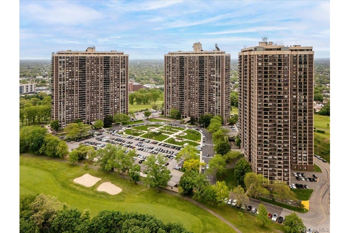 Aerial view of property and surrounding area with nearby urban area