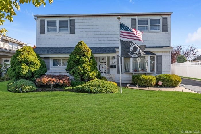 View of front of house with a shingled roof