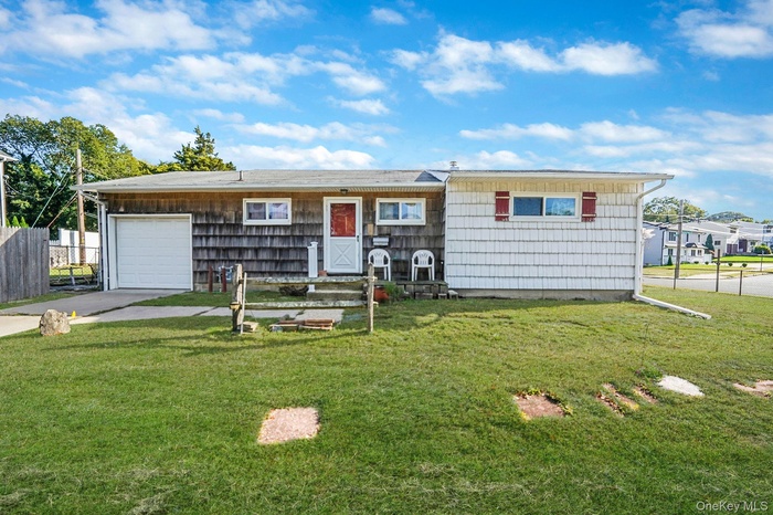 Ranch-style house featuring concrete driveway and an attached garage
