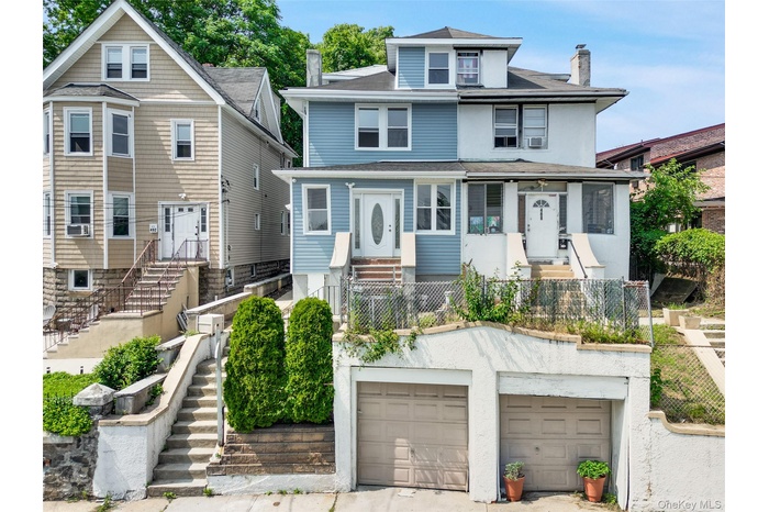 American foursquare style home featuring a chimney and a shingled roof