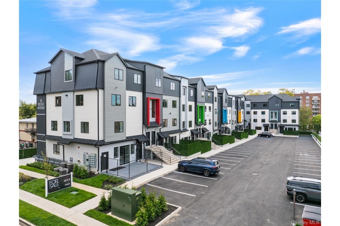 View of property with a residential view and uncovered parking