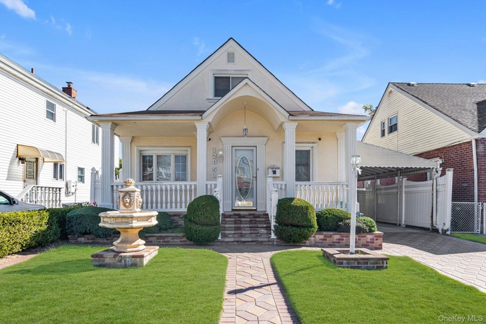 Bungalow-style home featuring stucco siding and a porch