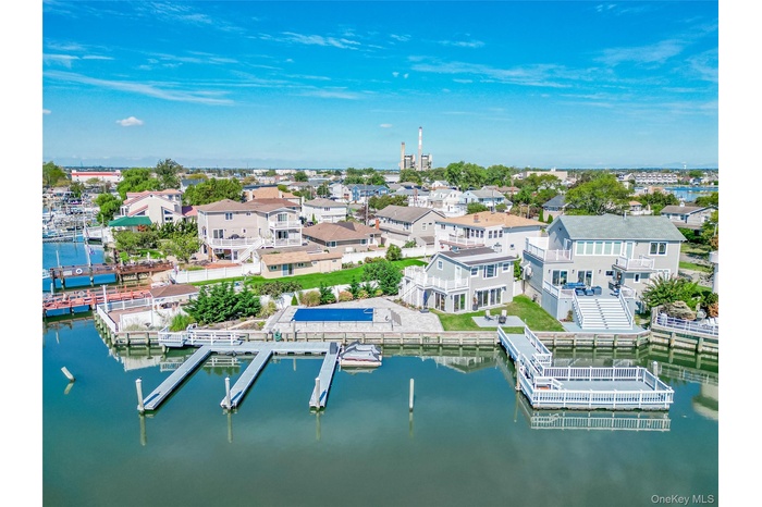 Aerial perspective of suburban area featuring a nearby body of water