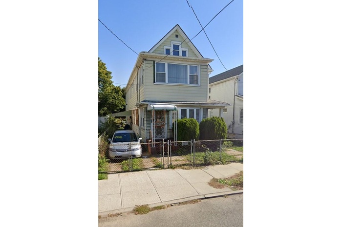View of front facade with a fenced front yard and a gate
