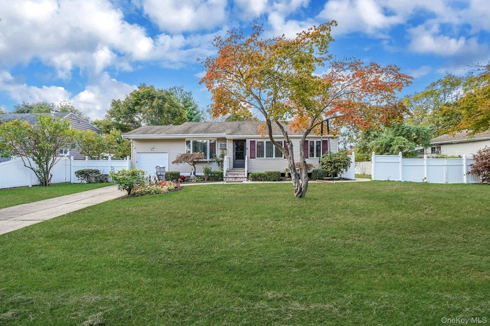 Single story home featuring an attached garage and concrete driveway