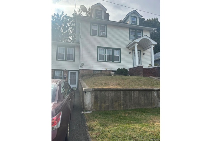 Traditional style home featuring a front yard