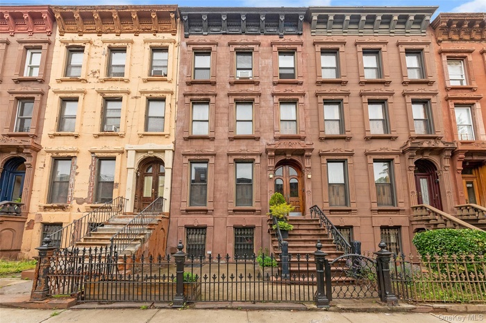 View of building exterior with a fenced front yard