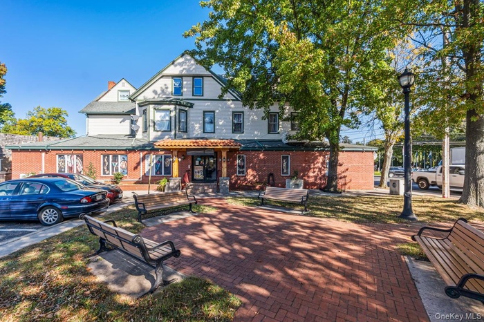 Back of property with brick siding and a chimney