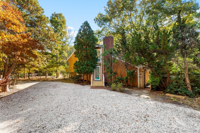 View of front of home with fence and a chimney